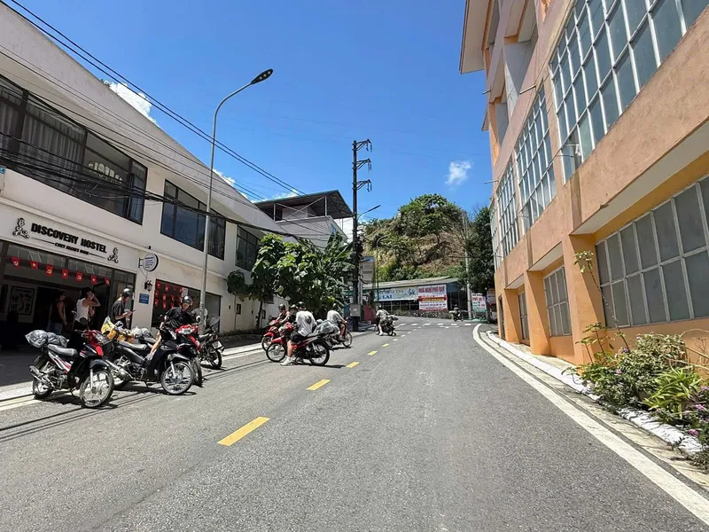 Riders loading motorbikes outside Discovery Hostel in Ha Giang city
